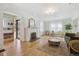Bright living room featuring hardwood floors, a fireplace, and an open layout at 1355 Hudson St, Denver, CO 80220