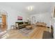 Open living room with hardwood floors, a fireplace, and stylish furnishings at 1355 Hudson St, Denver, CO 80220