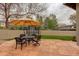 Backyard patio with a table, chairs, a trampoline, and plenty of space for outdoor gatherings at 2931 S Cook St, Denver, CO 80210