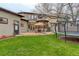A backyard with a patio, outdoor seating and a trampoline at 2931 S Cook St, Denver, CO 80210