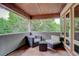 Cozy covered balcony with seating and views of the lush trees at 2931 S Cook St, Denver, CO 80210