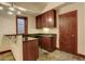 Basement bar area with dark cabinetry, a sink, and ample counter space for entertaining guests at 2931 S Cook St, Denver, CO 80210