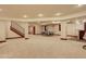 Spacious finished basement with stairs, neutral colors, a ping pong table, and a bar area at 2931 S Cook St, Denver, CO 80210