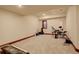 Versatile basement space with neutral carpet, drum set, and instruments for creative expression at 2931 S Cook St, Denver, CO 80210