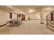 Large open basement featuring stairs, bar area, and space for games and relaxation at 2931 S Cook St, Denver, CO 80210