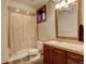 Bathroom featuring tile flooring, shower, and vanity with a mirror for everyday use at 2931 S Cook St, Denver, CO 80210