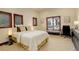 Cozy bedroom with natural light from three wood-trimmed windows and a comfortable bed at 2931 S Cook St, Denver, CO 80210