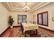 Bright dining room featuring an elegant chandelier, wood-trimmed windows, and a colorful rug at 2931 S Cook St, Denver, CO 80210
