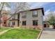Charming two-story home featuring a well-manicured lawn and inviting curb appeal with flowers at 2931 S Cook St, Denver, CO 80210