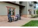 Inviting front porch with comfortable rocking chairs and charming flower arrangement at 2931 S Cook St, Denver, CO 80210