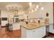 An expansive kitchen featuring white cabinets, granite countertops, and stainless steel appliances at 2931 S Cook St, Denver, CO 80210