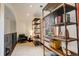 Bright loft area with rustic shelving, a comfortable chair, and a view of the outdoors at 2931 S Cook St, Denver, CO 80210