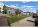 Well-maintained backyard with artificial grass, a concrete patio, and white picket fence at 5223 Gray Wolf Ln, Castle Rock, CO 80104