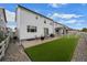 Spacious backyard featuring artificial turf, a concrete patio, and a white picket fence at 5223 Gray Wolf Ln, Castle Rock, CO 80104