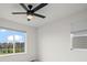 Bright bedroom with a large window and modern ceiling fan overlooks neighborhood at 5223 Gray Wolf Ln, Castle Rock, CO 80104