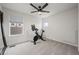 A bedroom with neutral carpet features a stationary bike, and a modern ceiling fan at 5223 Gray Wolf Ln, Castle Rock, CO 80104