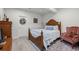 Cozy bedroom with decorative wreath, carved wood bed frame, and stylish rug at 5223 Gray Wolf Ln, Castle Rock, CO 80104