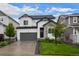 Charming two-story home with a gray garage door, stone accents and a well-manicured lawn at 5223 Gray Wolf Ln, Castle Rock, CO 80104