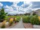 Community green space with walking path, landscaping, and neighborhood homes in the distance at 5223 Gray Wolf Ln, Castle Rock, CO 80104