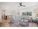 Open-concept living room seamlessly flows into the kitchen, featuring a large sectional sofa and wood floors at 5223 Gray Wolf Ln, Castle Rock, CO 80104