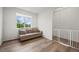 Cozy sitting area with a light-colored sofa, wood floors and natural light streaming through the window at 5223 Gray Wolf Ln, Castle Rock, CO 80104
