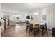 Open concept living space with wood floors, large windows and seamlessly connected living and dining areas at 5223 Gray Wolf Ln, Castle Rock, CO 80104