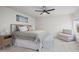 Bright main bedroom with a ceiling fan, a sitting area, and a large bed at 5223 Gray Wolf Ln, Castle Rock, CO 80104
