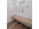 A bright mud room features a wooden bench, wood floors and decorative wall hooks at 5223 Gray Wolf Ln, Castle Rock, CO 80104