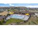 A bird's-eye view of a pool at a community center with pool umbrellas, lounge chairs and other community amenities at 5223 Gray Wolf Ln, Castle Rock, CO 80104