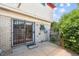 Patio with sliding glass doors leads to a brick home with a partially fenced yard at 6400 E Mississippi Ave, Denver, CO 80224