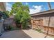 Enclosed backyard patio with wood fence and ample shade at 6400 E Mississippi Ave, Denver, CO 80224