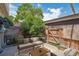 Private backyard patio with comfortable seating area and mature trees at 6400 E Mississippi Ave, Denver, CO 80224