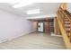 Finished basement with light vinyl floors, bright lighting and built-in shelving at 6400 E Mississippi Ave, Denver, CO 80224