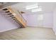 The finished basement has stairs, light vinyl floors, and bright lighting at 6400 E Mississippi Ave, Denver, CO 80224