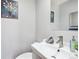 Cozy powder room featuring a modern sink, mirror, and decorative accents at 6400 E Mississippi Ave, Denver, CO 80224