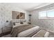 Bedroom is decorated with modern art and a comfortable bed at 6400 E Mississippi Ave, Denver, CO 80224