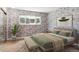 Inviting bedroom features calming colors, large window, and hardwood floors at 6400 E Mississippi Ave, Denver, CO 80224