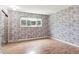 Bedroom featuring ample closet space and a large window, with light wood flooring at 6400 E Mississippi Ave, Denver, CO 80224
