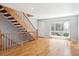 Bright entryway with hardwood floors, staircase, and large window at 6400 E Mississippi Ave, Denver, CO 80224