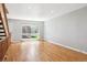 Bright living room with hardwood floors and a large window offering natural light at 6400 E Mississippi Ave, Denver, CO 80224
