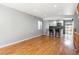 Spacious living area with wood floors, leading to the updated kitchen with bar stool seating at 6400 E Mississippi Ave, Denver, CO 80224