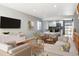 Bright living room with updated decor flowing into open kitchen and dining area at 6400 E Mississippi Ave, Denver, CO 80224