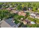 Aerial shot displays a large backyard with mature trees, lawn, patio, shed and play area at 7351 S Marion St, Centennial, CO 80122