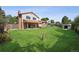 Spacious backyard with a large lawn, covered patio, brick chimney, and storage shed at 7351 S Marion St, Centennial, CO 80122