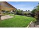 Enjoyable covered patio overlooking a large lawn with a privacy fence and garden area at 7351 S Marion St, Centennial, CO 80122