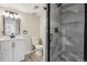 Modern bathroom with tiled walk-in shower, updated vanity, and modern lighting at 7351 S Marion St, Centennial, CO 80122
