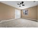 Bedroom includes carpet floors, tan walls, with closet and window that allows for natural light at 7351 S Marion St, Centennial, CO 80122