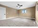 Bedroom features neutral walls, carpeted floors, a window that allows for natural light, and a modern ceiling fan at 7351 S Marion St, Centennial, CO 80122