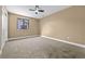 A bedroom features neutral walls, carpeted floors, and a modern ceiling fan at 7351 S Marion St, Centennial, CO 80122