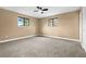 Bedroom features neutral walls, carpeted floors, two windows that allows for natural light, and a modern ceiling fan at 7351 S Marion St, Centennial, CO 80122
